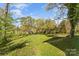 View of spacious backyard with a line of trees in the distance at 306 7Th Sw St, Hickory, NC 28602