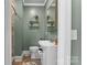 Modern half bathroom with a white sink, bronze decor and fixtures, and dark wood floors at 306 7Th Sw St, Hickory, NC 28602