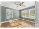 Bright bedroom with a ceiling fan, hardwood floors, and many windows at 306 7Th Sw St, Hickory, NC 28602