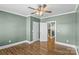 The spacious bedroom boasts hardwood floors, fresh paint and a modern ceiling fan at 306 7Th Sw St, Hickory, NC 28602