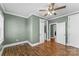 Bedroom with hardwood floors, modern ceiling fan and trim, and two doorways at 306 7Th Sw St, Hickory, NC 28602