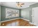 Bedroom featuring hardwood floors, large windows, and white door with updated fixtures at 306 7Th Sw St, Hickory, NC 28602