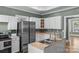 Updated kitchen features white cabinets, stainless steel appliances, and a double basin sink at 306 7Th Sw St, Hickory, NC 28602