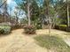Private backyard surrounded by mature trees and lush landscaping at 3711 Cole Mill Rd, Charlotte, NC 28270
