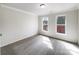 Cozy bedroom features neutral carpet, a window with tree views, and base molding creating a comfortable retreat at 3711 Cole Mill Rd, Charlotte, NC 28270