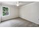 Clean bedroom with neutral carpet, a bright window, and overhead lighting at 3711 Cole Mill Rd, Charlotte, NC 28270