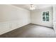 Comfortable bedroom has carpet, chair rails, two windows with tree views, and base molding creating a calming space at 3711 Cole Mill Rd, Charlotte, NC 28270