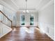 The bright dining room has hardwood floors, large windows, chair rails, and a modern chandelier for elegant dining at 3711 Cole Mill Rd, Charlotte, NC 28270