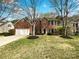 Charming two-story brick home with a well-manicured lawn and attached two car garage at 3711 Cole Mill Rd, Charlotte, NC 28270