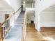 Bright foyer features hardwood floors, staircase, and open floor plan to the living room and offers a welcoming entrance at 3711 Cole Mill Rd, Charlotte, NC 28270