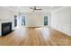 Bright living room features a fireplace, large windows, and beautiful hardwood floors, creating a cozy and inviting atmosphere at 3711 Cole Mill Rd, Charlotte, NC 28270