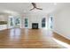 Open living room boasts a fireplace, hardwood floors, and plenty of natural light at 3711 Cole Mill Rd, Charlotte, NC 28270