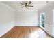 Spacious living room features crown molding, hardwood floors and natural light from a large window creating an inviting space at 3711 Cole Mill Rd, Charlotte, NC 28270