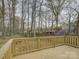 Wood deck overlooks yard with trees and wooden fence at 4427 Gaynelle Dr, Charlotte, NC 28215