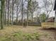 Large backyard features a wood deck, trees and a fire pit at 4427 Gaynelle Dr, Charlotte, NC 28215