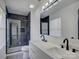 Modern bathroom with double sink, shower, and sleek finishes at 4427 Gaynelle Dr, Charlotte, NC 28215