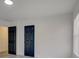 Vacant room has light gray floors and white walls with a modern black painted door at 4427 Gaynelle Dr, Charlotte, NC 28215