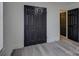 Bedroom closet with black doors and gray wood-look laminate flooring at 4427 Gaynelle Dr, Charlotte, NC 28215