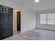 An empty bedroom features gray floors, white walls, and bright, natural lighting from the window at 4427 Gaynelle Dr, Charlotte, NC 28215