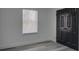Gray floors, white walls, window with blinds, and modern black door at 4427 Gaynelle Dr, Charlotte, NC 28215
