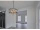 Bright dining room with view to adjacent living spaces, featuring a modern chandelier at 4427 Gaynelle Dr, Charlotte, NC 28215