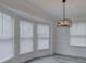 Bright dining room featuring a modern chandelier and large windows with abundant natural light at 4427 Gaynelle Dr, Charlotte, NC 28215
