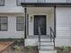 Inviting front porch with black railings and steps leading to a black front door at 4427 Gaynelle Dr, Charlotte, NC 28215