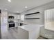 Bright, open kitchen with stainless steel appliances and white countertops, leading to a dining area at 4427 Gaynelle Dr, Charlotte, NC 28215