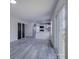 Open living area leading to a modern kitchen, with sleek gray flooring and natural light at 4427 Gaynelle Dr, Charlotte, NC 28215