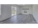 Bright living room featuring a white brick fireplace and sliding glass doors to the backyard at 4427 Gaynelle Dr, Charlotte, NC 28215
