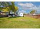 Large, grassy backyard with a storage shed, wooden fence, and mature trees, perfect for outdoor activities at 48 Mandalay Sw Pl, Concord, NC 28027
