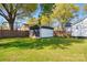 Expansive backyard featuring a detached garage, a wooden fence and a well-maintained lawn with lush trees at 48 Mandalay Sw Pl, Concord, NC 28027