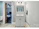 Bathroom vanity and a view into an adjacent bedroom at 48 Mandalay Sw Pl, Concord, NC 28027