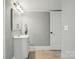 Bright bathroom featuring white vanity and a wall mirror at 48 Mandalay Sw Pl, Concord, NC 28027