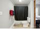 Compact bathroom with a tile floor, a black shower curtain and neutral grey walls at 48 Mandalay Sw Pl, Concord, NC 28027