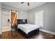 Comfortable bedroom featuring a sliding barn door, hardwood floors and a plush bed at 48 Mandalay Sw Pl, Concord, NC 28027