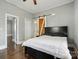 Cozy bedroom featuring a sliding barn door, hardwood floors and a plush bed at 48 Mandalay Sw Pl, Concord, NC 28027