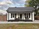 Charming single-story home with a covered front porch and a well-maintained lawn at 48 Mandalay Sw Pl, Concord, NC 28027