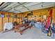 A tidy detached garage featuring plywood walls, a picnic table, and organized storage solutions at 48 Mandalay Sw Pl, Concord, NC 28027