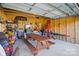 Organized detached garage featuring a picnic table, shelving, tools, and overhead lighting at 48 Mandalay Sw Pl, Concord, NC 28027