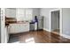 Bright kitchen with white cabinets, stainless steel appliances, and hardwood floors at 48 Mandalay Sw Pl, Concord, NC 28027
