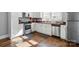 Bright kitchen with white cabinets, stainless steel appliances, and hardwood floors at 48 Mandalay Sw Pl, Concord, NC 28027