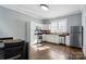 Bright kitchen featuring white cabinets, stainless steel appliances, and hardwood floors at 48 Mandalay Sw Pl, Concord, NC 28027