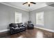 Bright living room featuring hardwood floors and two windows bringing in lots of natural light at 48 Mandalay Sw Pl, Concord, NC 28027
