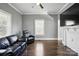 Cozy living room with hardwood floors, modern gray walls and trim, and a ceiling fan with a light at 48 Mandalay Sw Pl, Concord, NC 28027