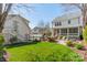 Expansive backyard featuring green grass, stone outdoor kitchen, and a screened in porch at 4912 Kenbury Ct, Fort Mill, SC 29708