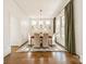Bright dining room with modern chandelier, hardwood floors, and green accents at 4912 Kenbury Ct, Fort Mill, SC 29708
