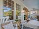Inviting front porch with rocking chairs, ceiling fans, and wood accents at 4912 Kenbury Ct, Fort Mill, SC 29708