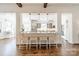 Stylish kitchen with bar seating featuring pendant lights and white cabinetry at 4912 Kenbury Ct, Fort Mill, SC 29708