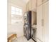 Convenient laundry room features a stacked washer and dryer, wine fridge, and custom cabinets at 4912 Kenbury Ct, Fort Mill, SC 29708